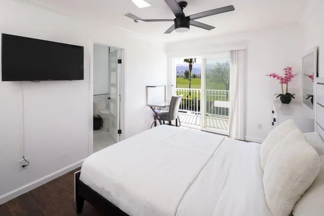 a bedroom with a bed and a flat screen tv