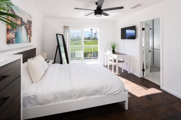 a bed sitting in a bedroom next to a window