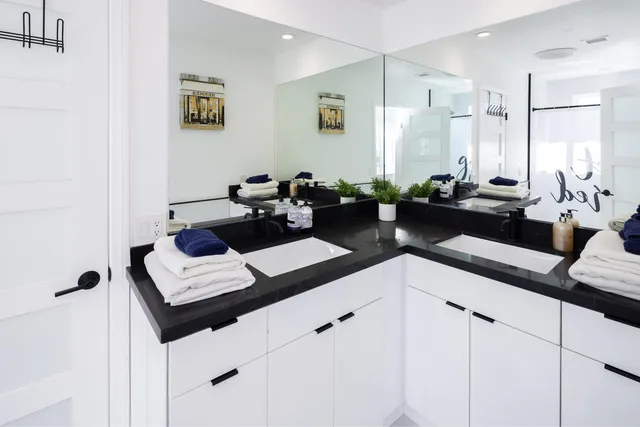 a kitchen with a sink cabinets and living room