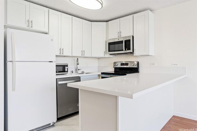 a kitchen with a refrigerator and a stove