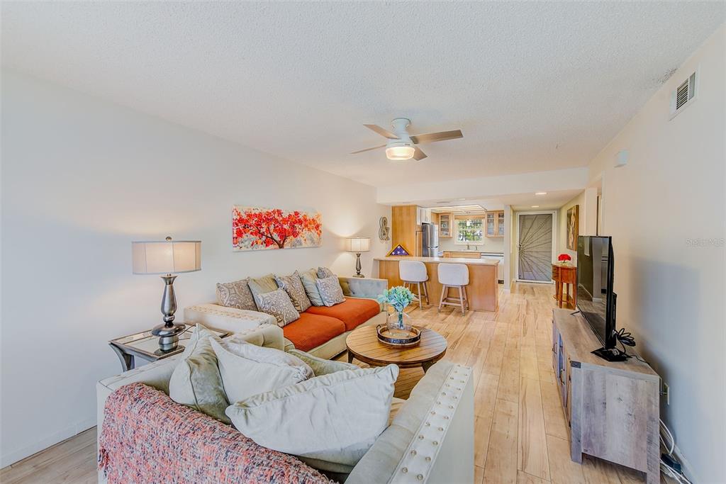 12900 Vonn Road, Unit E205 Largo, FL 33774 - Photo 11 of 35 a living room with furniture and a flat screen tv