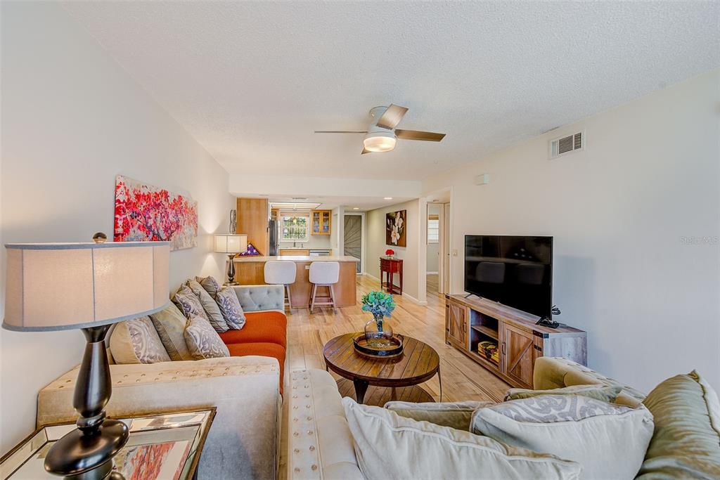12900 Vonn Road, Unit E205 Largo, FL 33774 - Photo 12 of 35 a living room with furniture and a flat screen tv