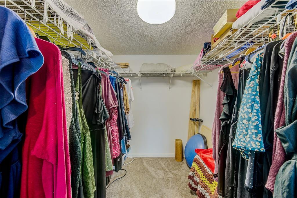 12900 Vonn Road, Unit E205 Largo, FL 33774 - Photo 17 of 35 a view of walk in closet with clothes and shoes