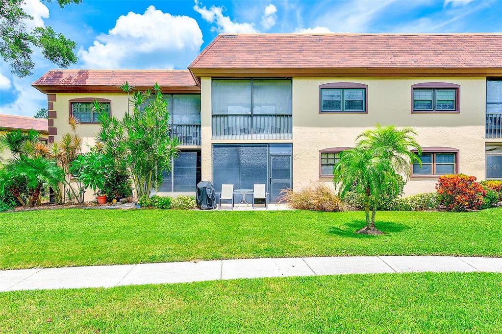 12900 Vonn Road, Unit E205 Largo, FL 33774 - Photo 28 of 35 a view of a house with a yard