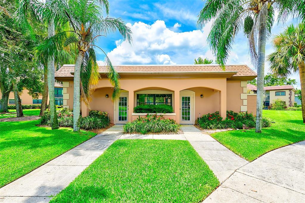 12900 Vonn Road, Unit E205 Largo, FL 33774 - Photo 30 of 35 a view of a house with a yard