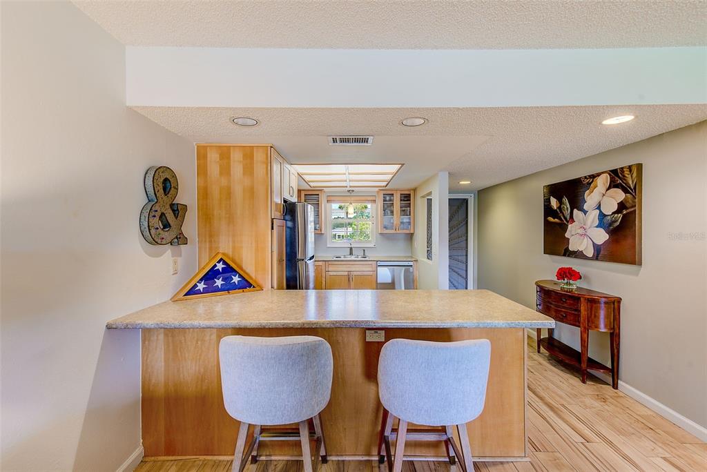 12900 Vonn Road, Unit E205 Largo, FL 33774 - Photo 4 of 35 a view of a dining room with furniture and wooden floor