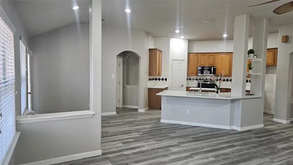 a kitchen with a sink a counter and cabinets