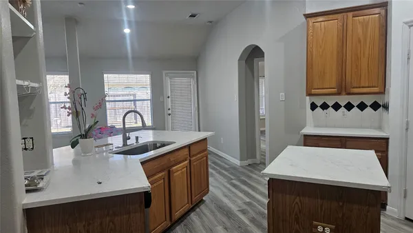 a kitchen with sink refrigerator and window
