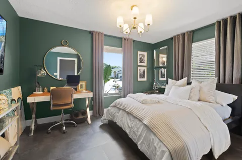 a bedroom with a bed and a flat screen tv