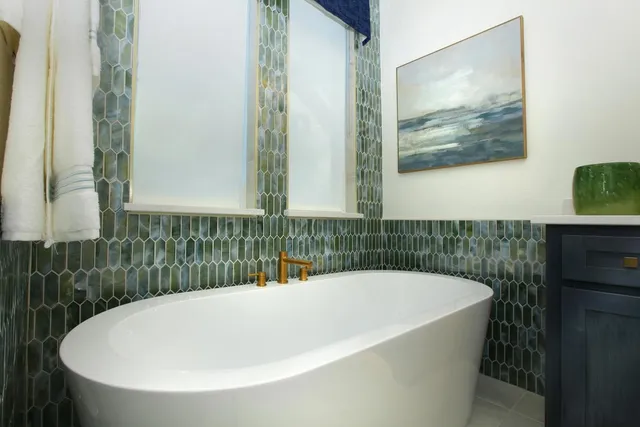 a bathroom with a bathtub and a shower