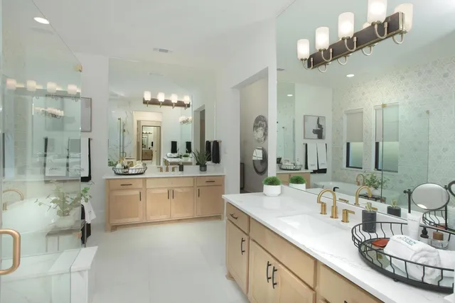 a large bathroom with a double vanity sink a mirror and a bathtub
