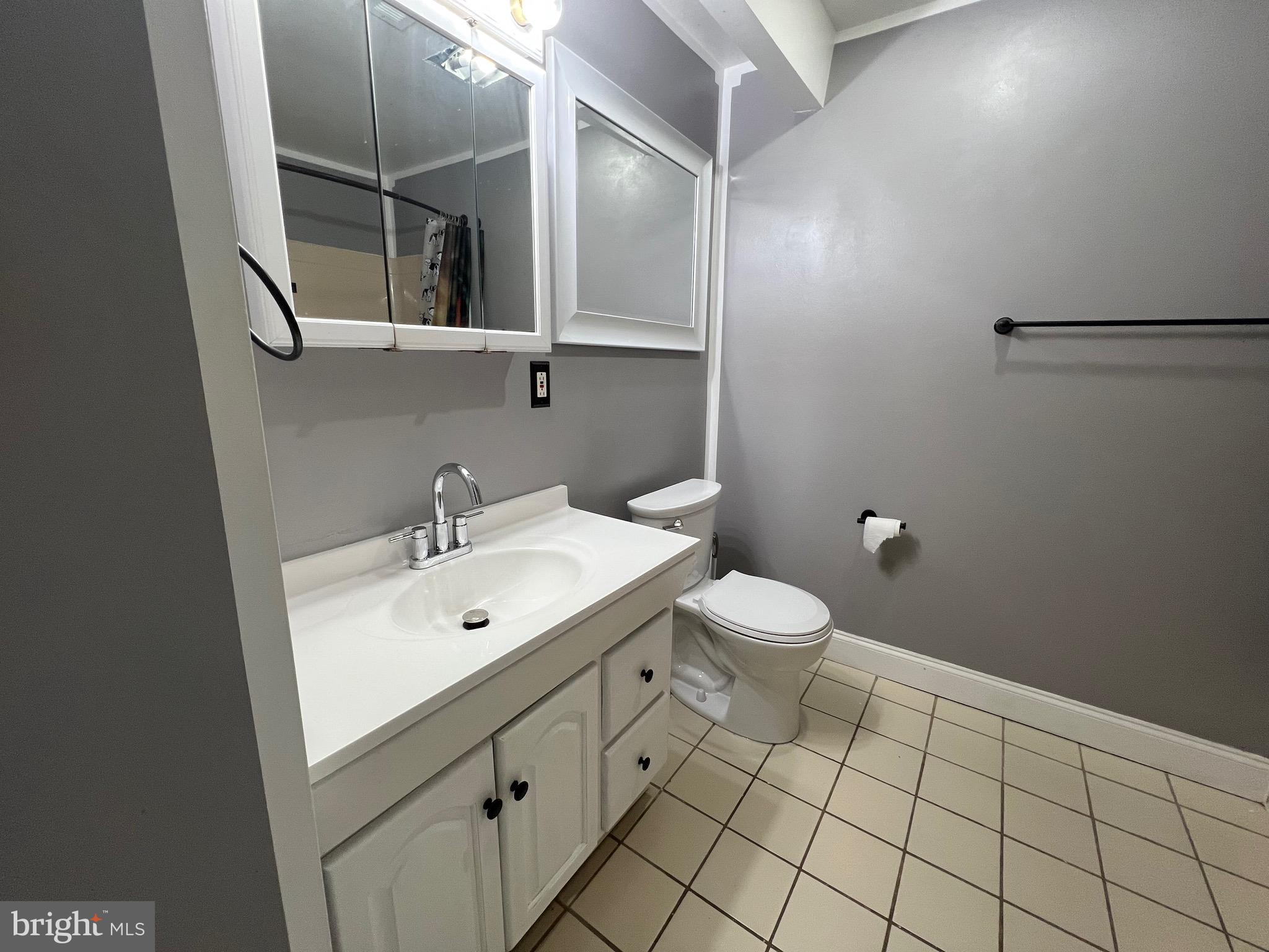4127 Cresson Street, Unit 2F Philadelphia, PA 19127 - Photo 12 of 14 a bathroom with a sink mirror and toilet
