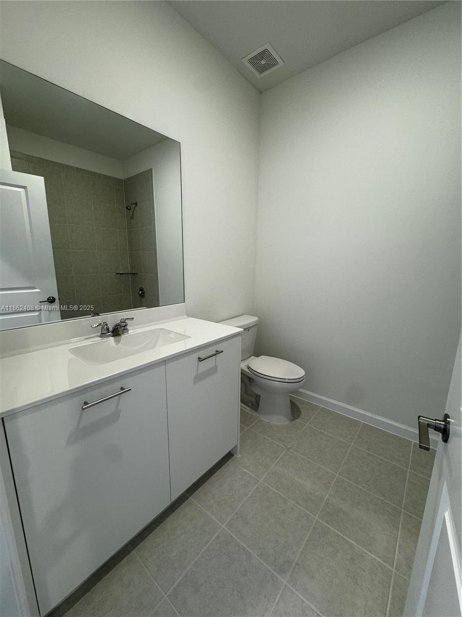2325 Northwest 125 Street, Unit 2325 Miami, FL 33167 - Photo 12 of 18 a bathroom with a sink toilet and a mirror
