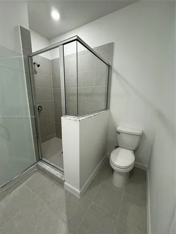 a bathroom with a toilet a sink and shower