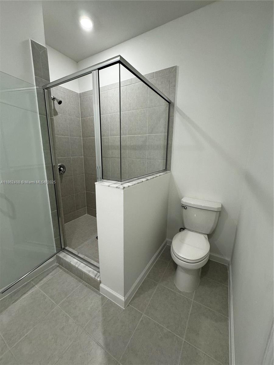 2325 Northwest 125 Street, Unit 2325 Miami, FL 33167 - Photo 13 of 18 a bathroom with a toilet a sink and shower