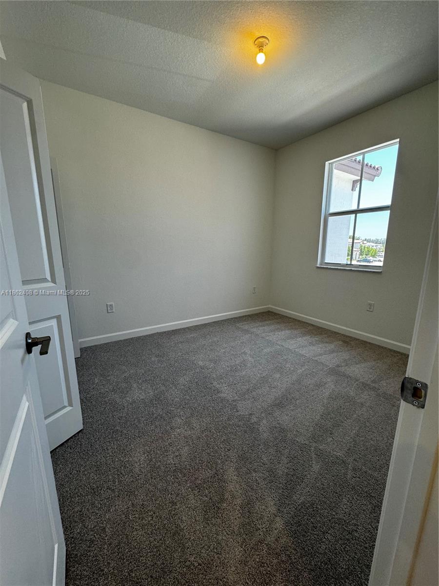 2325 Northwest 125 Street, Unit 2325 Miami, FL 33167 - Photo 17 of 18 an empty room with windows