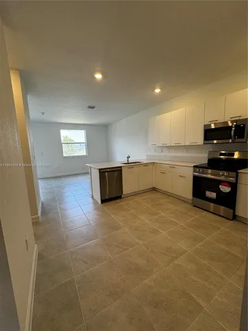 a kitchen with stainless steel appliances granite countertop a sink and cabinets