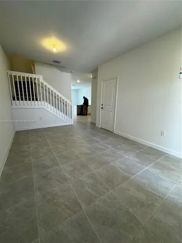 a view of an empty room with windows