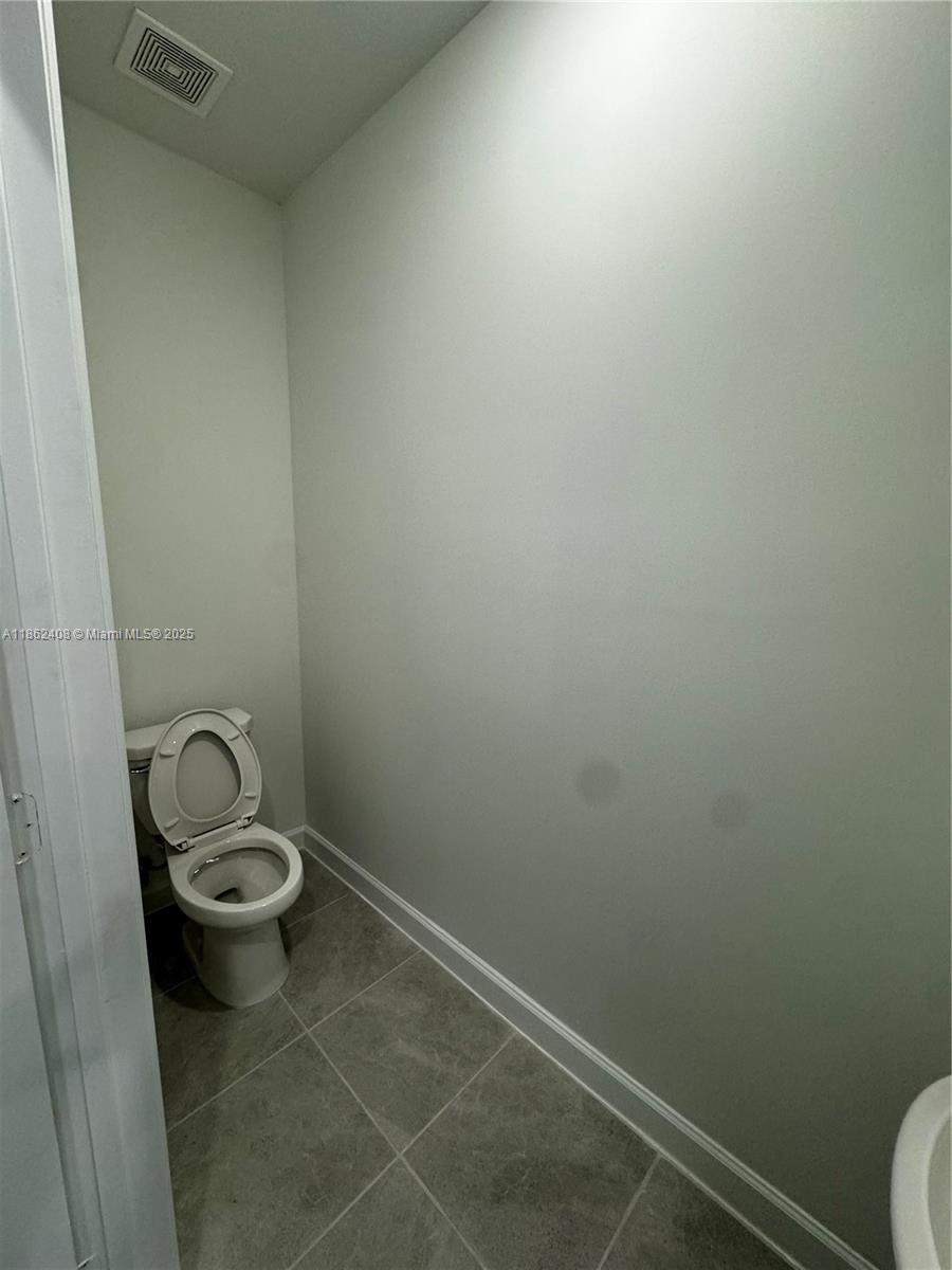 2325 Northwest 125 Street, Unit 2325 Miami, FL 33167 - Photo 6 of 18 a bathroom with a sink and a toilet