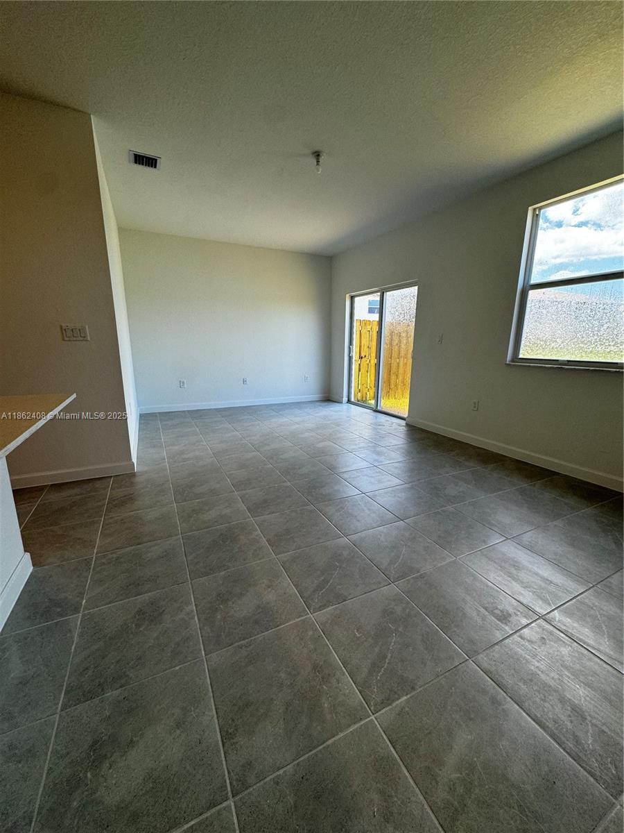 2325 Northwest 125 Street, Unit 2325 Miami, FL 33167 - Photo 7 of 18 a view of an empty room with a window