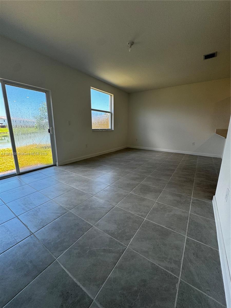 2325 Northwest 125 Street, Unit 2325 Miami, FL 33167 - Photo 9 of 18 a view of an empty room with a window