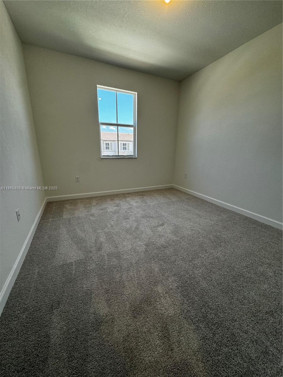 2325 Northwest 125 Street, Unit 2325 Miami, FL 33167 - Photo 10 of 18 an empty room with a window