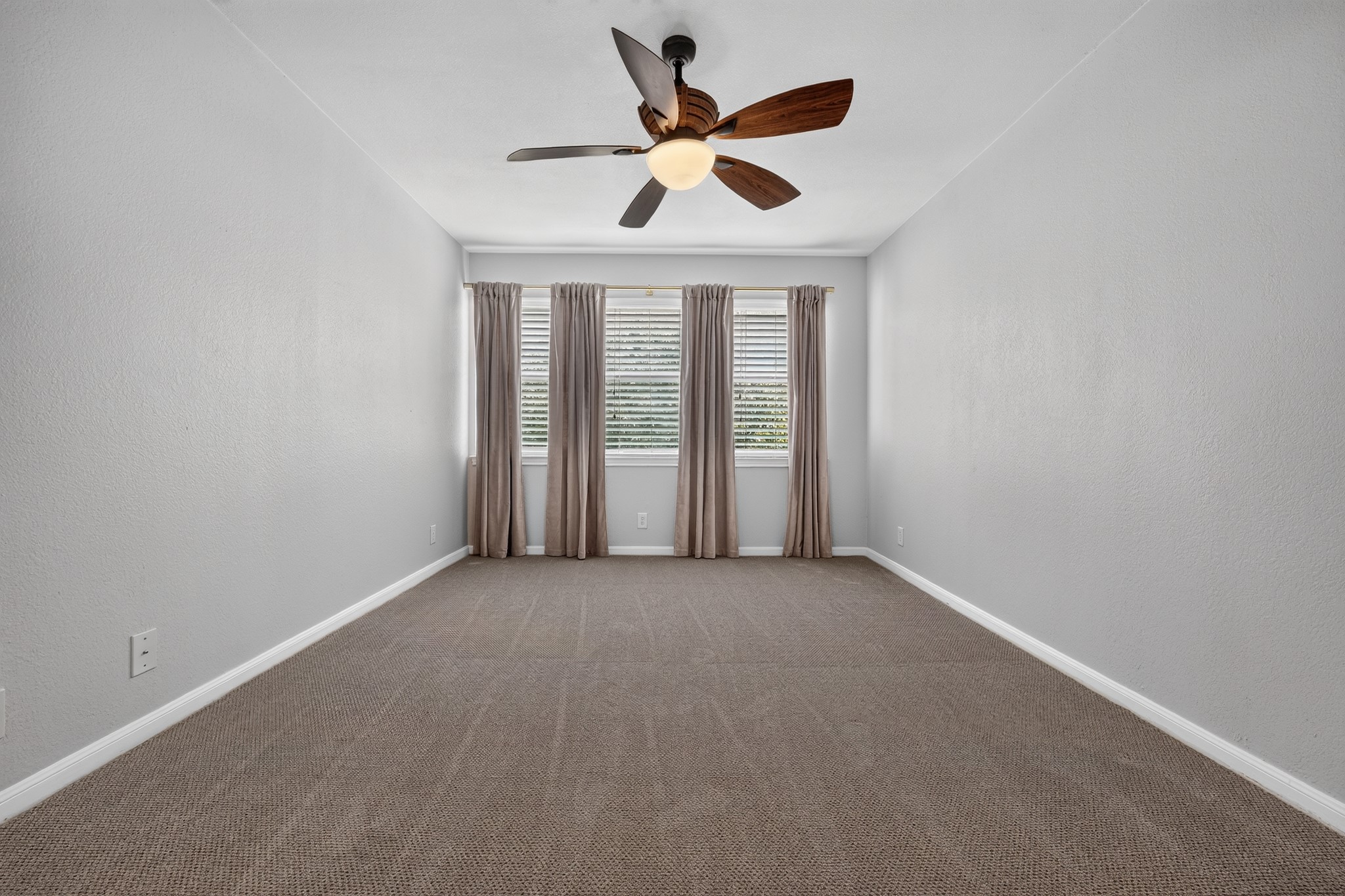 3845 Ranch Road 2222, Unit 32 Austin, TX 78731 - Photo 10 of 24 Bedroom with window treatment and curtains