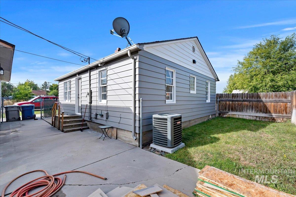 10 Harrell Street Boise, ID 83706 - Photo 14 of 20 Light gray siding exterior with a dark entry door, covered front porch, and concrete walkway