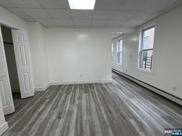 a view of a room with wooden floor and a window