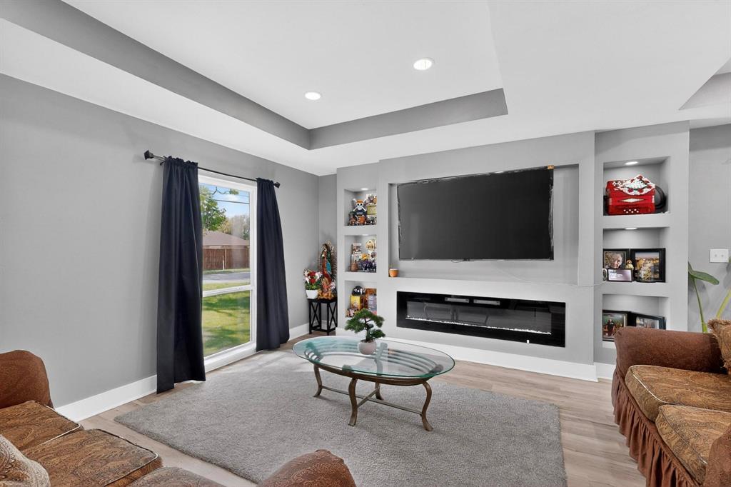 602 North Bagdad Road Grand Prairie, TX 75050 - Photo 12 of 39 a living room with furniture and a flat screen tv