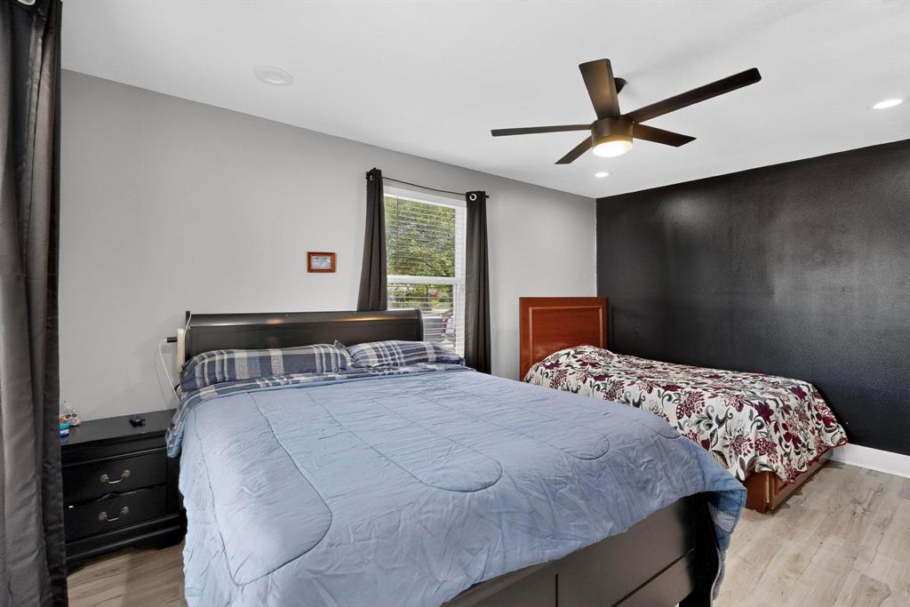 602 North Bagdad Road Grand Prairie, TX 75050 - Photo 21 of 39 a bedroom with a bed and a painting on the wall