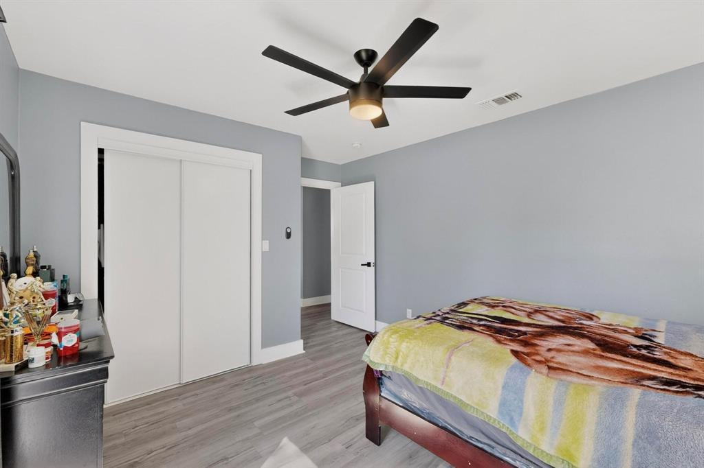 602 North Bagdad Road Grand Prairie, TX 75050 - Photo 27 of 39 a bedroom with a bed and wooden floor