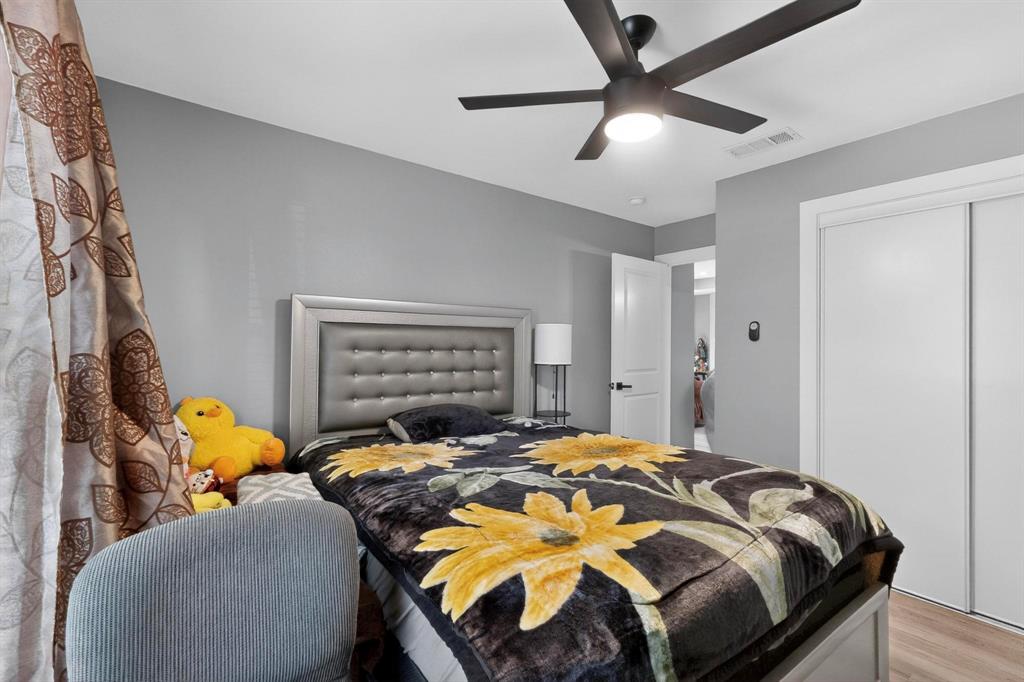 602 North Bagdad Road Grand Prairie, TX 75050 - Photo 29 of 39 a bed sitting in a bedroom next to a window and a ceiling fan