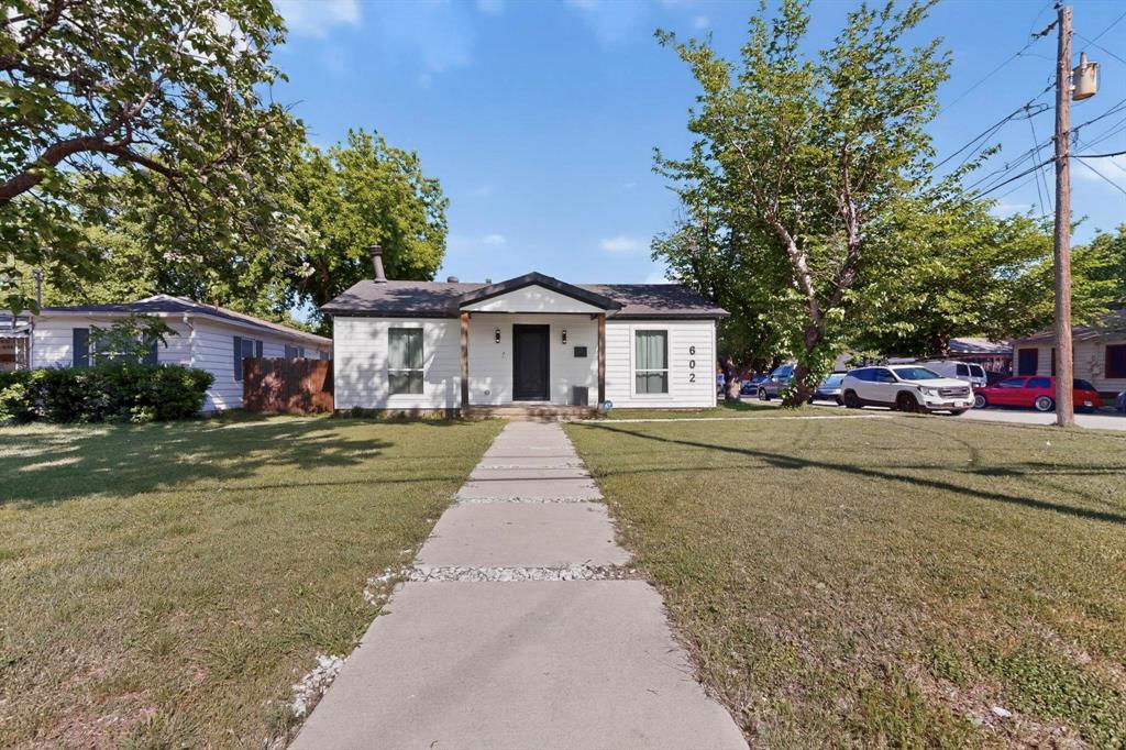 602 North Bagdad Road Grand Prairie, TX 75050 - Photo 6 of 39 a front view of a house with a yard and garage