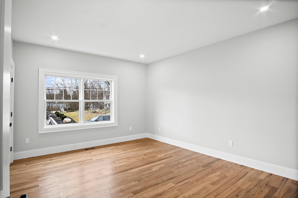 43 Samoset Road Woburn, MA 01801 - Photo 18 of 30 an empty room with wooden floor and windows