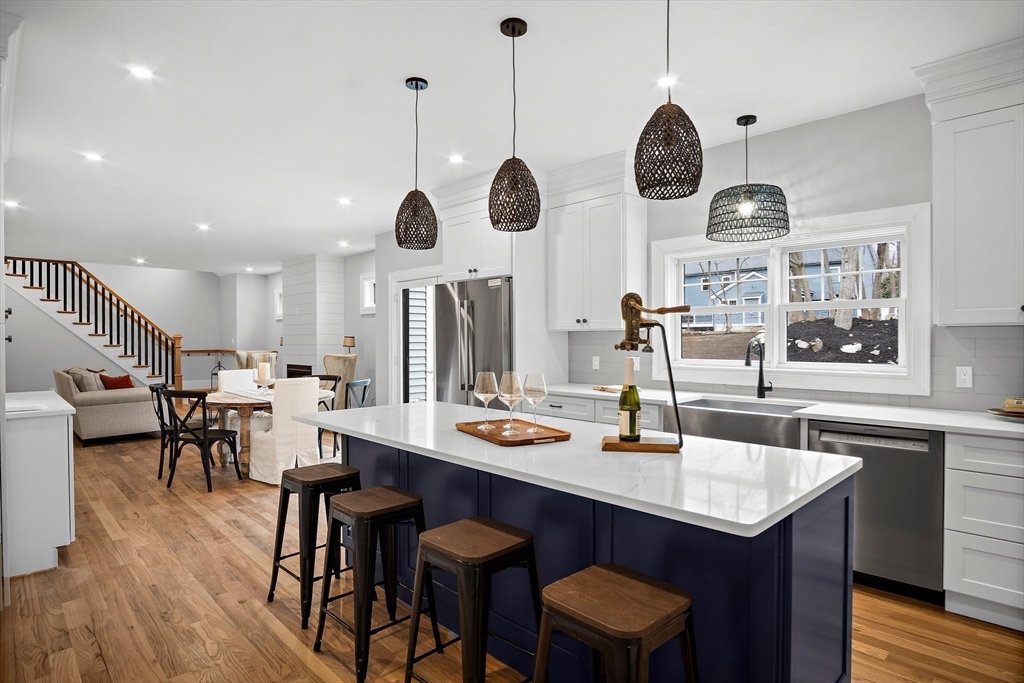 43 Samoset Road Woburn, MA 01801 - Photo 2 of 30 a dining room with wooden floor stainless steel appliances a chandelier