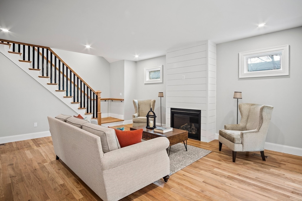 43 Samoset Road Woburn, MA 01801 - Photo 6 of 30 a living room with couches chairs and a fireplace