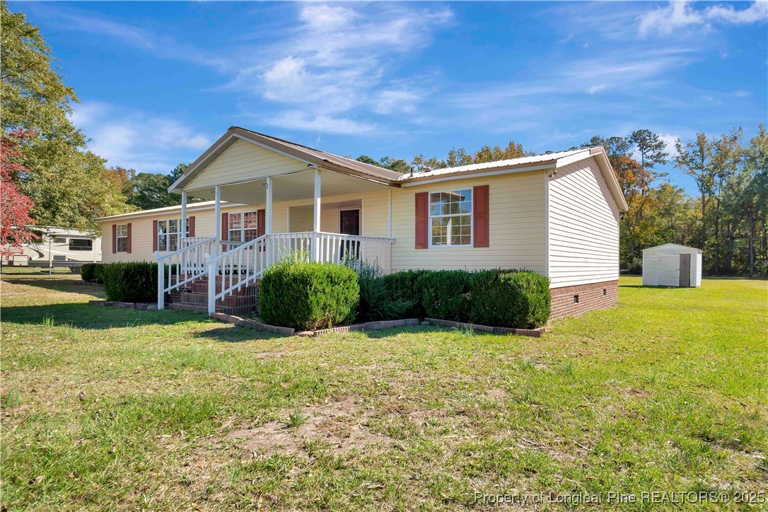 2589 Pleasant Hope Road Fairmont, NC 28340 - Photo 1 of 36 a view of a house with a yard and potted plants