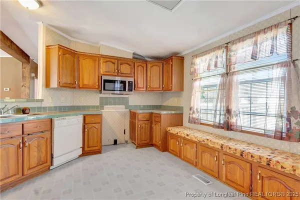 a large kitchen with stainless steel appliances granite countertop a stove a sink and a granite counter tops