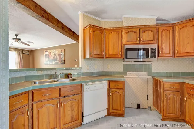 a kitchen with stainless steel appliances granite countertop a sink stove and microwave