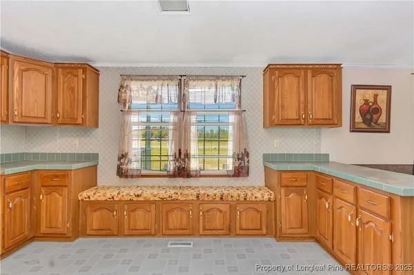 a bathroom with a tub a sink and a large window