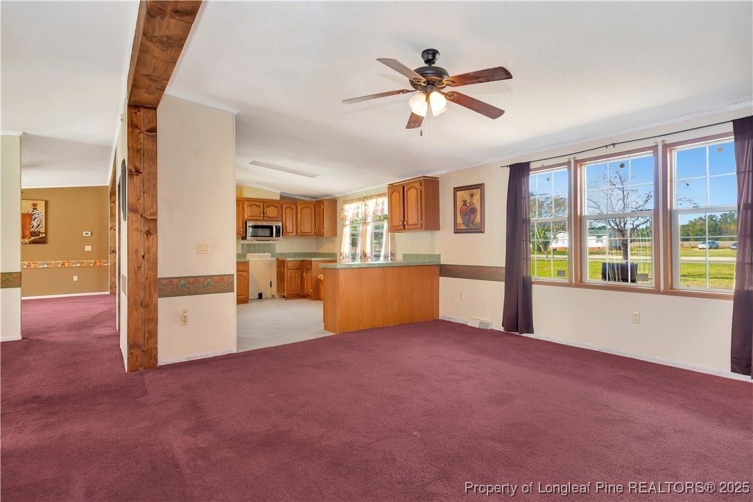 2589 Pleasant Hope Road Fairmont, NC 28340 - Photo 17 of 36 a view of an empty room with a window and kitchen view