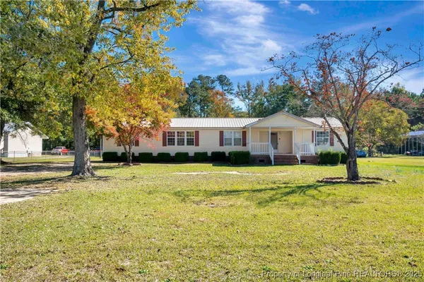 a front view of house with yard and swimming pool