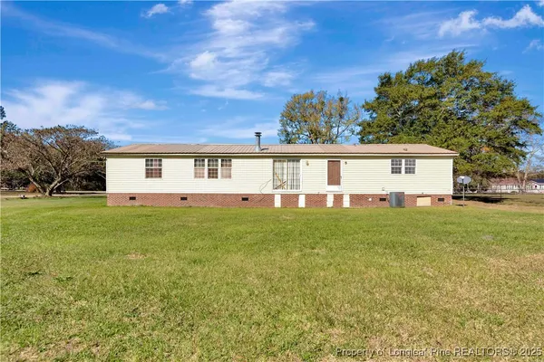 a view of a house with a backyard