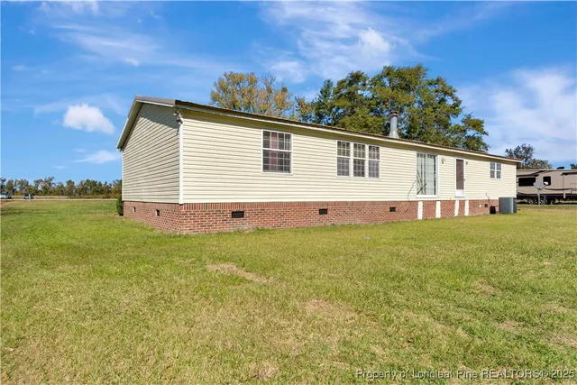 a view of house with backyard