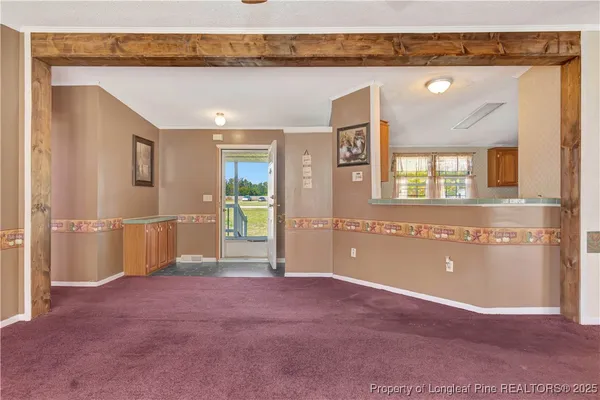 a view of a livingroom with an empty space and a window