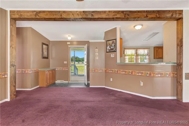 a view of a livingroom with an empty space and a window