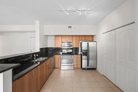 a kitchen with stainless steel appliances a refrigerator and a stove top oven