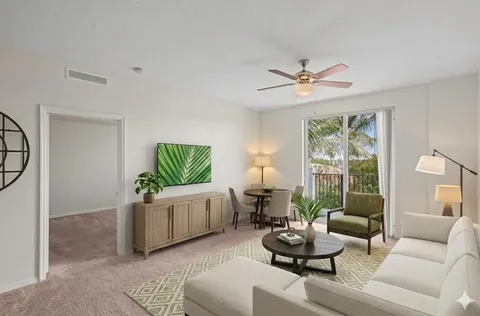 a living room with furniture and kitchen view