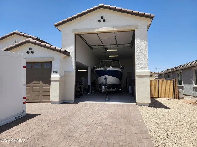 a view of an empty room with wooden floor and window